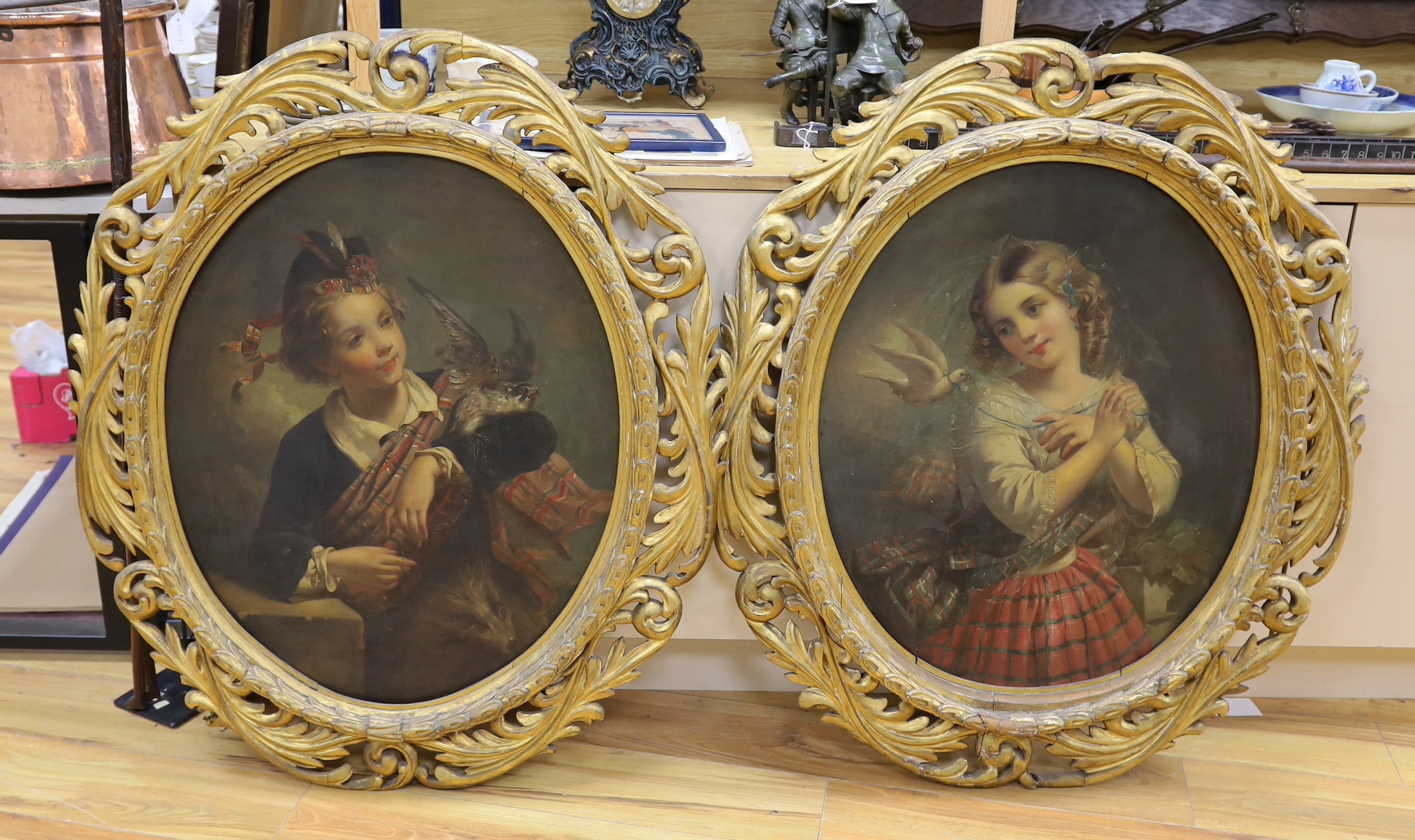 Edwin Landseer (British, 1802-1873) Scottish youth holding a hawk and girl with a dove, pair of oleographs she signed in the plate and dated 1856, ovals, 71 x 58cm. Ornate gilt wood frames